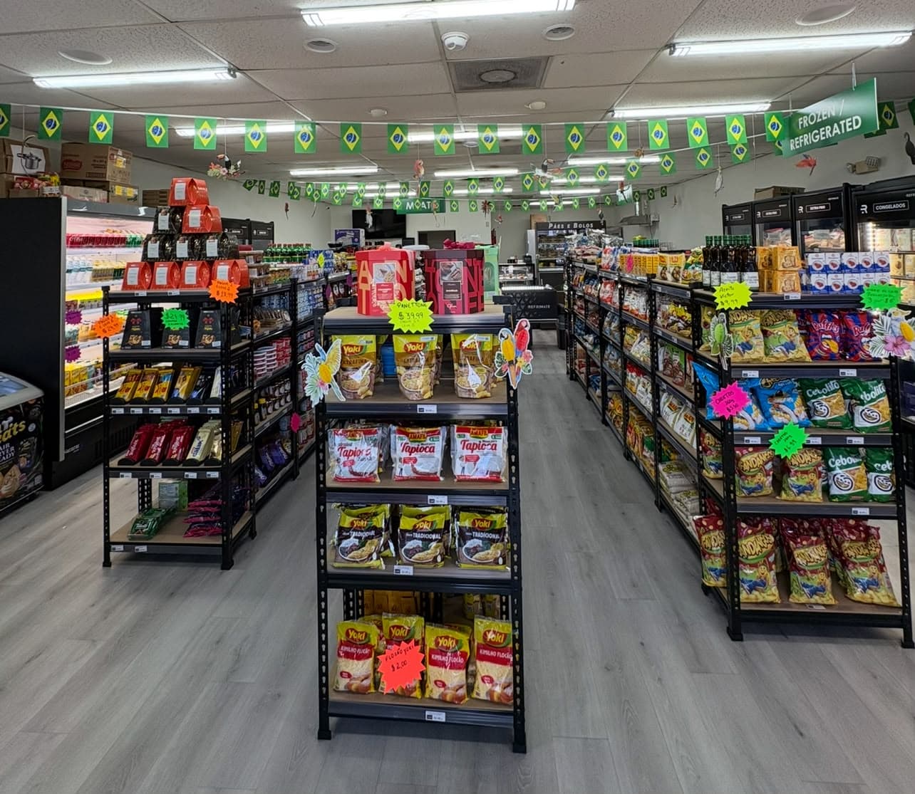 Corredores do Sambrazil Market com produtos e bandeirinhas brasileiras